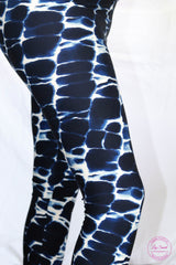 Blue and white leggings resembling ocean waves