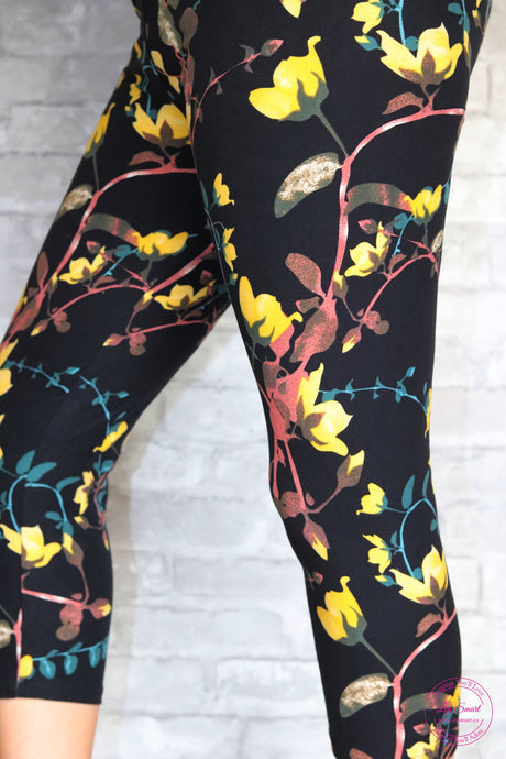 black capri leggings printed with a cheerful floral pattern